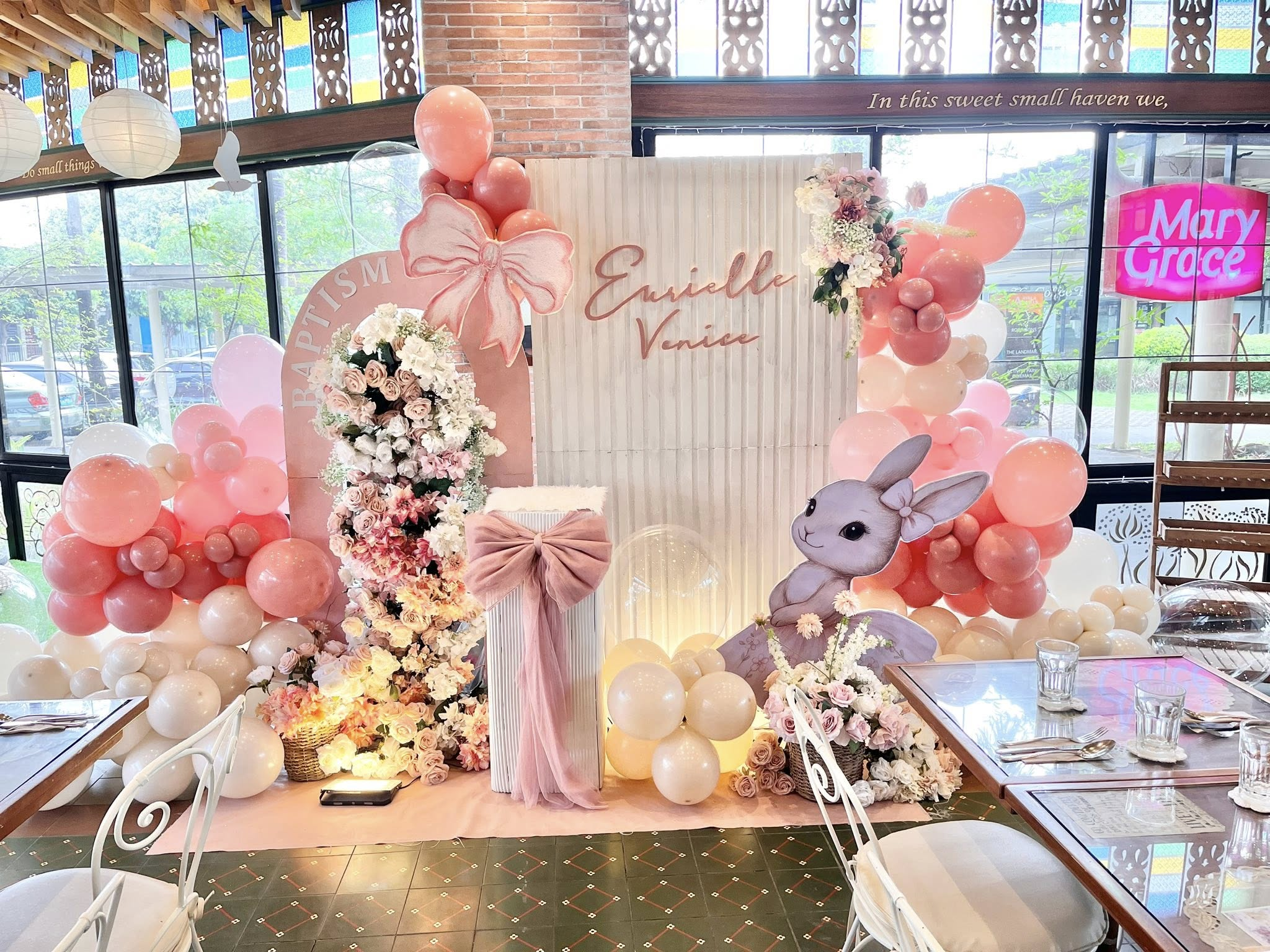 Eurielle Venice baptism setup — pink florals and balloon arch